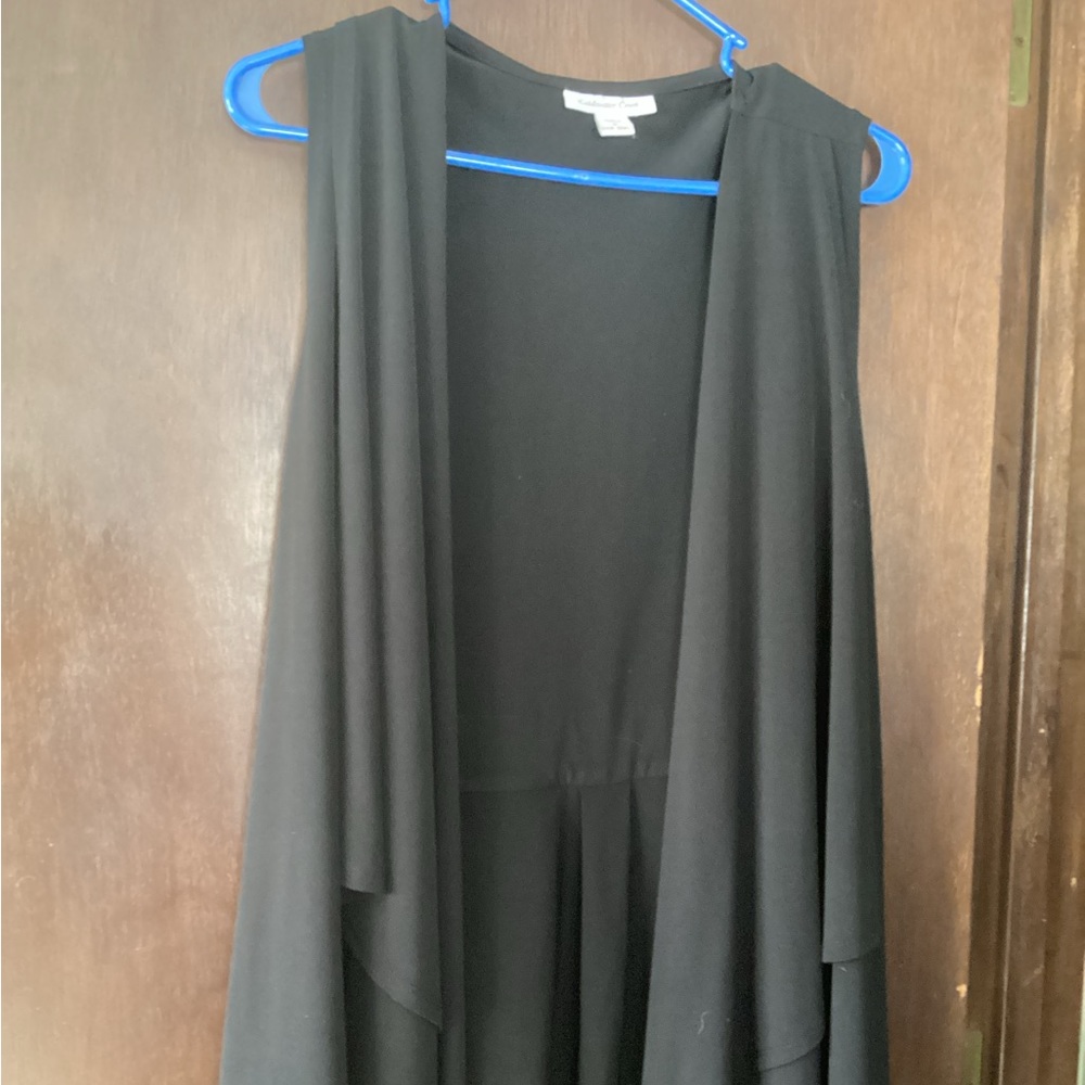 Knit vest with ruffled bottom.